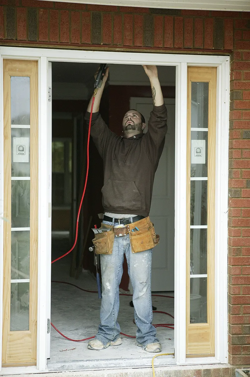 Restoration contractor making interior wall repairs to a storm-flooded home in Austell, Cobb County