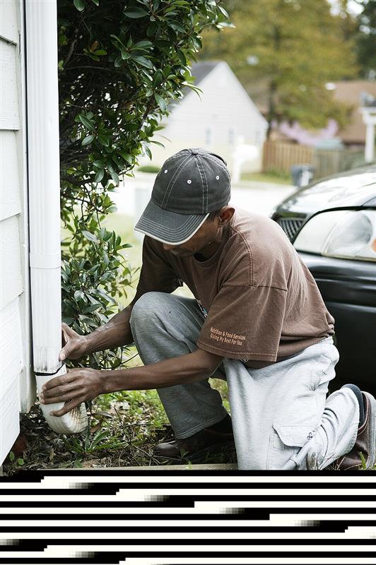 Restoration contractor repairing flood-damaged home wall structure